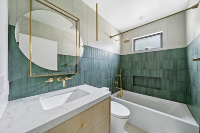 Alcove bathtub - mid-sized contemporary green tile and ceramic tile single-sink alcove bathtub idea in Los Angeles with flat-panel cabinets, light wood cabinets, quartz countertops and a floating vanity