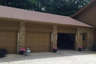 This is an example of a large arts and crafts two-storey brown exterior in Indianapolis with stone veneer.