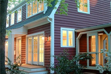 Example of a classic red two-story wood exterior home design in Raleigh with a gambrel roof