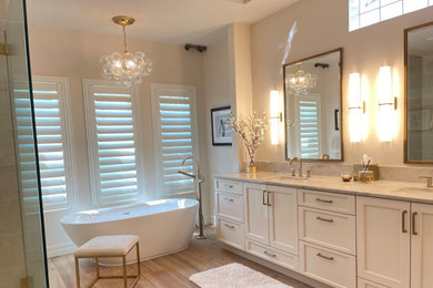 Example of a trendy master beige tile and porcelain tile wood-look tile floor, brown floor, double-sink and tray ceiling bathroom design in Tampa with shaker cabinets, beige cabinets, a bidet, beige walls, an undermount sink, quartzite countertops, beige countertops and a built-in vanity