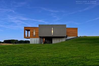 Mid-sized mid-century modern two-story wood house exterior photo in Other
