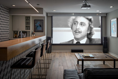 Small minimalist light wood floor and brown floor basement photo in Atlanta with a bar and gray walls