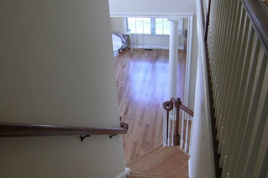 Inspiration for a large transitional wooden l-shaped staircase remodel in New York with painted risers