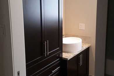 Inspiration for a small transitional 3/4 beige tile and ceramic tile ceramic tile and gray floor corner shower remodel in Calgary with dark wood cabinets, beige walls, a vessel sink, shaker cabinets, a wall-mount toilet, granite countertops and a hinged shower door