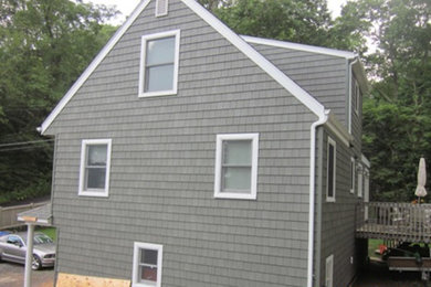 Inspiration for a large gray two-story wood exterior home remodel in New York