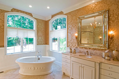 Example of a large transitional master travertine floor and beige floor bathroom design in Charleston with furniture-like cabinets, beige cabinets, multicolored walls, an undermount sink, a hinged shower door and beige countertops