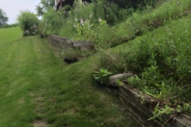 Inspiration for a large modern backyard retaining wall landscape in Other for summer.