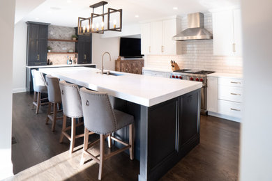 Inspiration for a mid-sized transitional l-shaped brown floor eat-in kitchen remodel in Chicago with recessed-panel cabinets, white cabinets, quartz countertops, ceramic backsplash, an island and white countertops