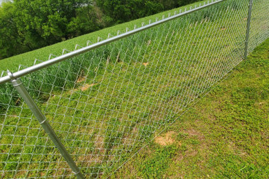 Photo of a large modern backyard metal fence outdoor basketball/tennis/multi-game court in Charlotte.
