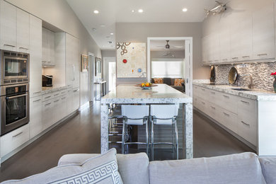 Eat-in kitchen - mid-sized contemporary galley dark wood floor eat-in kitchen idea in Miami with an undermount sink, granite countertops, stainless steel appliances, an island, flat-panel cabinets, multicolored backsplash and matchstick tile backsplash