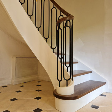 Curved staircase with iron balustrade