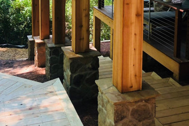 Inspiration for a craftsman backyard deck remodel in Atlanta with a roof extension
