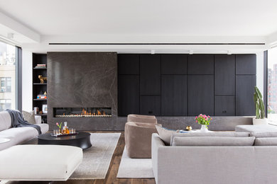 Living room - contemporary medium tone wood floor and brown floor living room idea in New York with a ribbon fireplace