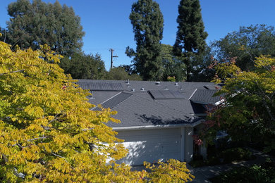 Example of a mid-sized classic beige one-story house exterior design in Santa Barbara with a shingle roof