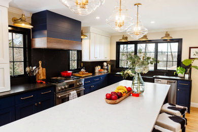 Inspiration for a mid-sized transitional l-shaped medium tone wood floor and brown floor eat-in kitchen remodel in New York with a farmhouse sink, shaker cabinets, blue cabinets, quartz countertops, black backsplash, quartz backsplash, stainless steel appliances, an island and white countertops