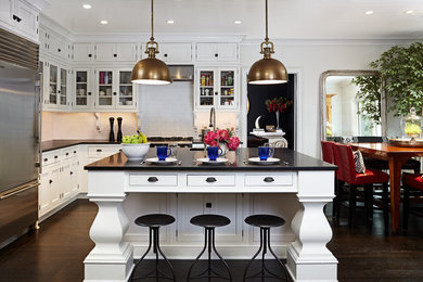 Inspiration for a timeless l-shaped dark wood floor eat-in kitchen remodel in DC Metro with an undermount sink, glass-front cabinets, white cabinets, granite countertops, white backsplash, subway tile backsplash and an island