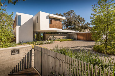 Large modern two-storey white exterior in Los Angeles with wood siding and a flat roof.