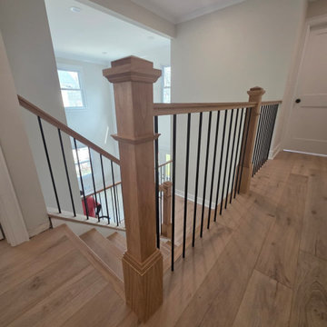 Metal and Wood Indoor Railing Installation with Red Oak T-Rail & Black Balusters