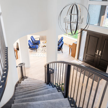 Black and Nickel Curved Staircase with Black Risers