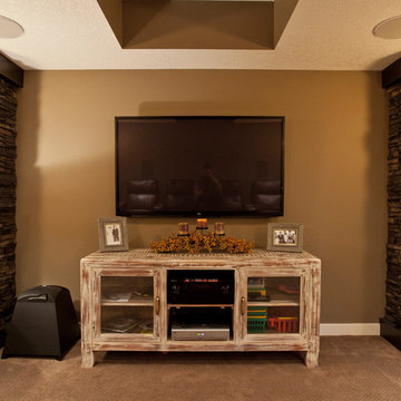 Media room with rustic console and stone pillars