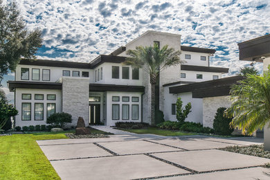 Example of a large minimalist white three-story mixed siding exterior home design in Toronto