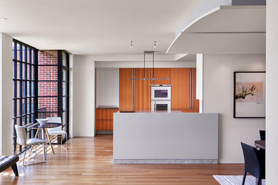 Inspiration for a mid-sized contemporary light wood floor and brown floor kitchen/dining room combo remodel in DC Metro with white walls