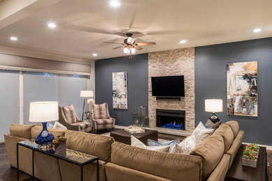 Family room - mid-sized transitional open concept laminate floor and brown floor family room idea in Austin with gray walls, a standard fireplace, a stacked stone fireplace and a wall-mounted tv