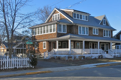 Inspiration for a large coastal brown three-story wood gable roof remodel in New York