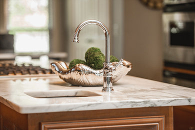 Mid-sized transitional u-shaped dark wood floor and brown floor eat-in kitchen photo in Nashville with marble countertops, white backsplash, subway tile backsplash, stainless steel appliances, an island, an undermount sink, raised-panel cabinets, brown cabinets and white countertops