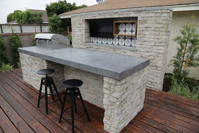 Mid-sized transitional backyard patio kitchen photo in Orange County with decking and no cover
