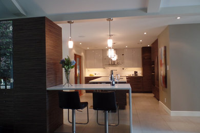 Example of a mid-sized transitional l-shaped porcelain tile and beige floor enclosed kitchen design in Other with an undermount sink, flat-panel cabinets, medium tone wood cabinets, quartz countertops, white backsplash, subway tile backsplash, paneled appliances and an island