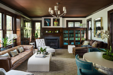 Inspiration for a large transitional enclosed family room in Columbus with a library, beige walls, dark hardwood floors, a standard fireplace, a brick fireplace surround, no tv and brown floor.