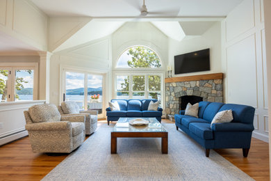 Lakefront Living Room with Vaulted Ceilings and Stone Fireplace