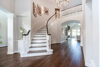 Inspiration for a modern wooden curved wood railing staircase remodel in Houston