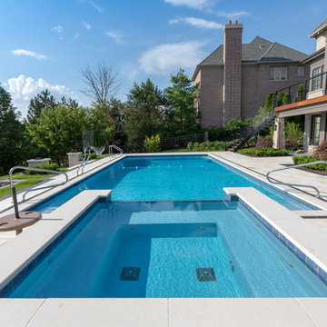 Burr Ridge Lap Pool with Raised Hot Tub and Waterfall