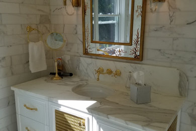 Example of a mid-sized ornate master white tile and marble tile marble floor and white floor tub/shower combo design in Other with furniture-like cabinets, white cabinets, an undermount tub, a bidet, white walls, an undermount sink, marble countertops, a hinged shower door and white countertops