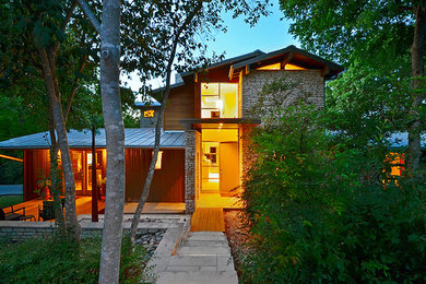 Photo of a mid-sized modern two-storey white exterior in Austin with mixed siding.