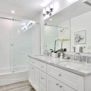 Mid-sized transitional white tile and porcelain tile porcelain floor bathroom photo in Los Angeles with an undermount sink, shaker cabinets, white cabinets, marble countertops, a one-piece toilet and white walls