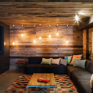 Industrial open plan home cinema in Sydney with multi-coloured walls, concrete flooring, a projector screen and grey floors.
