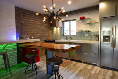 Example of a trendy light wood floor kitchen design in Phoenix with open cabinets, blue backsplash, ceramic backsplash, stainless steel appliances and no island