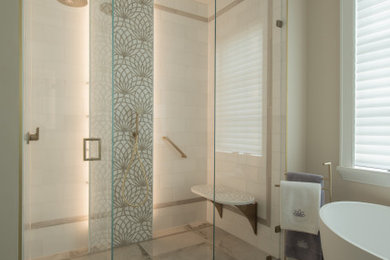 Design ideas for a large modern ensuite bathroom in DC Metro with freestanding cabinets, white cabinets, a freestanding bath, a built-in shower, a bidet, beige tiles, marble tiles, beige walls, a submerged sink, engineered stone worktops, a hinged door, brown worktops, a shower bench, double sinks and a freestanding vanity unit.