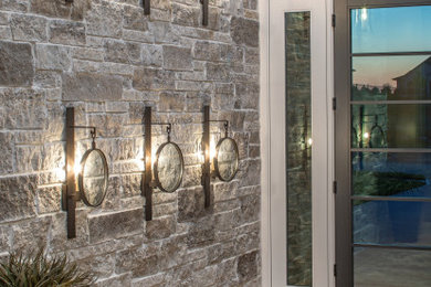 Inspiration for a contemporary medium tone wood floor entryway remodel in Omaha with beige walls and a black front door