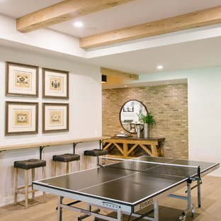 Inspiration for a large classic walk-out basement in Atlanta with white walls, light hardwood flooring, a standard fireplace, a concrete fireplace surround and brown floors.