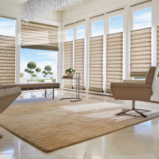 Inspiration for a large modern study in New York with white walls, limestone flooring, a freestanding desk and beige floors.