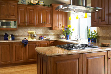 Transitional u-shaped eat-in kitchen photo in San Francisco with an undermount sink, raised-panel cabinets, medium tone wood cabinets, granite countertops, beige backsplash, stone tile backsplash and stainless steel appliances