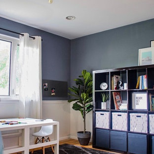 Inspiration for a medium sized modern craft room in Philadelphia with blue walls, medium hardwood flooring, no fireplace, a freestanding desk and brown floors.