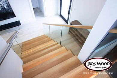 Wooden glass railing staircase photo in Houston