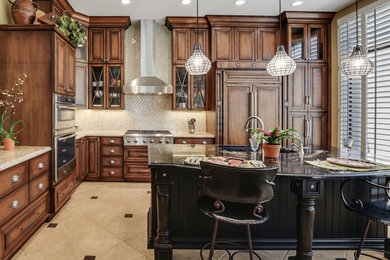 Open concept kitchen - large transitional l-shaped travertine floor and beige floor open concept kitchen idea in Phoenix with a double-bowl sink, raised-panel cabinets, distressed cabinets, marble countertops, beige backsplash, mosaic tile backsplash, paneled appliances, an island and multicolored countertops