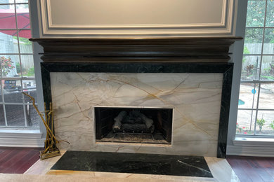 Example of a mid-sized living room design in Houston with a standard fireplace and a stone fireplace