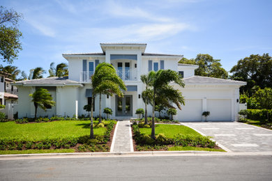 Example of a trendy white two-story house exterior design in Miami with a hip roof, a shingle roof and a gray roof